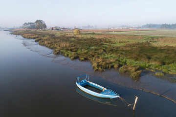 aveiro wooden boats from aerial view with fog at sunrise