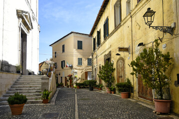 Fototapeta premium A narrow street among the old houses of Fiuggi, a medieval village in the Lazio region.