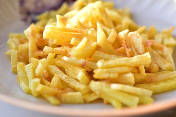 Ruddy delicious crispy French fries just fried close up