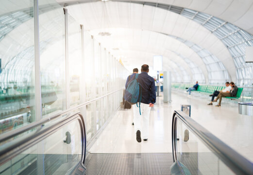traveler with travel bag or luggage walking in the airport termi - Powered by Adobe