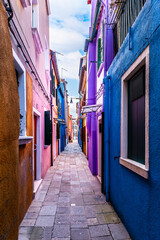 Alleyway with colorful facades on the island of Burano in Venice in Veneto, Italy