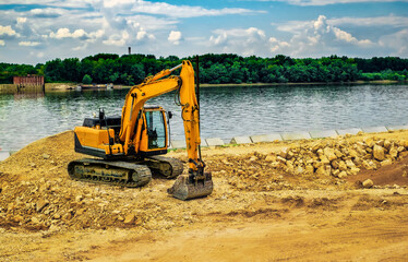 The modern excavator performs excavation work on the construction site in Ruse city, Bulgaria.