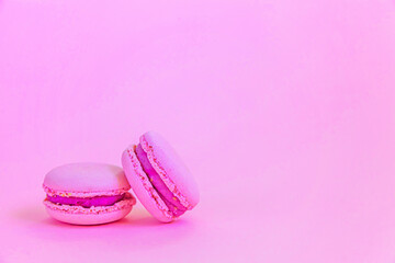Sweet almond colorful unicorn pink macaron or macaroon dessert cake isolated on trendy pink pastel...
