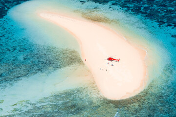 Sand bank with helicopter and coral reef © Liam M