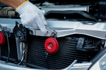 Auto mechanic working in garage. Repair service.