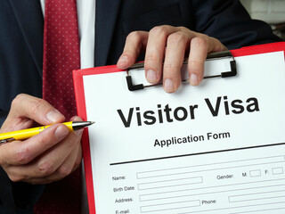 Visitor visa application form. The lawyer offers papers.