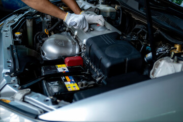 Auto mechanic working in garage. Repair service.