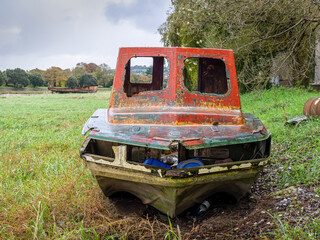 Abandoned old boat, seems to have toothless face.