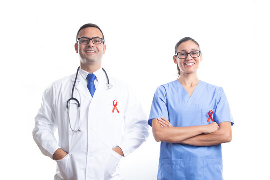 Doctor and nurse with red AIDS ribbon on white background. World AIDS Day  concept.