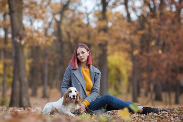 young beautiful woman playing with her dogs  in the autumn outdoor