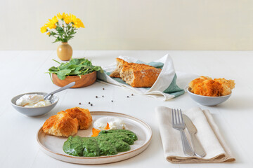 Homemade fresh creamy spinach and poached egg with roasted bread. Delicious healthy brunch or lunch.