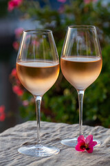 Tasting of local rose wine in summer with sail boats haven of Port Grimaud on background, Provence, France
