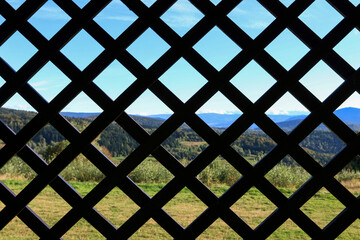 Vast space seen through the bars. Lost freedom metaphor.