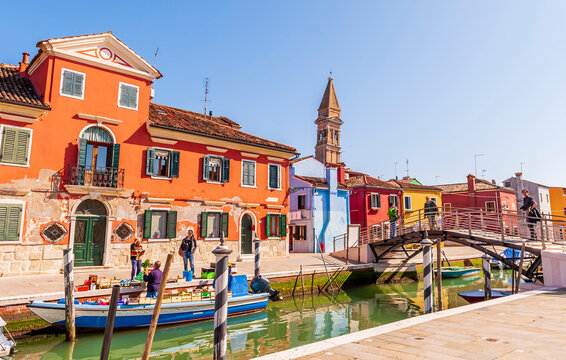 Street and colorful facades on a canal on the island of Burano in Venice in Veneto, Italy