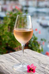 Tasting of local rose wine in summer with sail boats haven of Port Grimaud on background, Provence, France