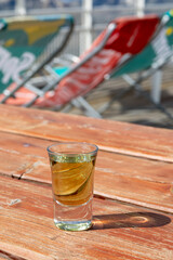 Tasting of very sweet french green strong liqueur based on many herbs, plants and flowers from Chartreuse abbey in Alpine mountains