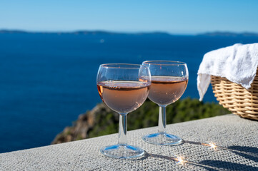 Picnic with of local rose wine and blue Mediterranean sea on background, near Saint-Tropez, Var, Provence, France
