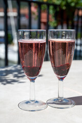 Summer party with sparkling rose champagne wine and sail boats haven of Port Grimaud on background, Provence, France