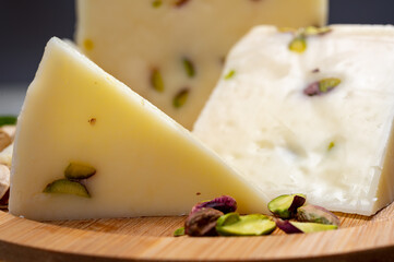 Cheese collection, fresh Italian pecorino cheese made from sheep milk filled with pistachio nuts from Bronte, Sicily