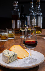 Tasting and pairing of different cheeses with strong alcoholic drinks, whisky, cognac or calvados