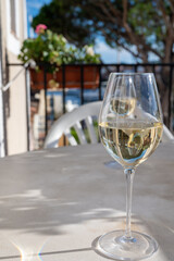 Tasting of local white wine on sunny summer balcony Provence, France