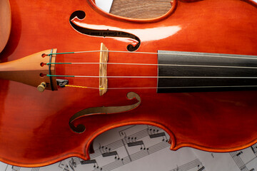 Fototapeta premium Violin body with an unrecognizable musical score