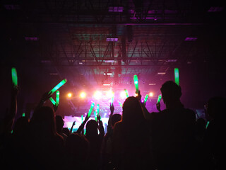 Crowd at concert : Silhouette people crowd happy and cheering with led foam stick light in front of...