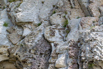 Natural wavy rocky formation along the river. Abstract rough natural background