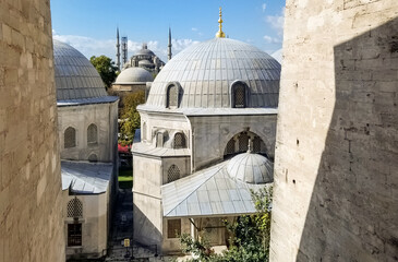 View from a window on the Hagia Sophia lookout out over domes, minarets and the Blue Mosque in the distance, in Istanbul, Turkey.
