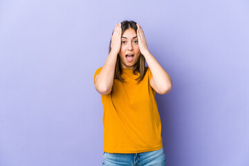 Young caucasian woman having fun covering half of face with palm.