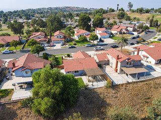 Fototapeta na wymiar Aerial view of Southern California houses in inland town Corona, during hot summer. USA
