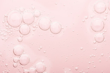 Transparent texture of moisturizing serum on a pink background. Gel water lotion for skincare....
