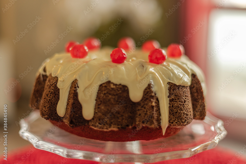 Wall mural bundt cake with white chocolate and candied cherries.