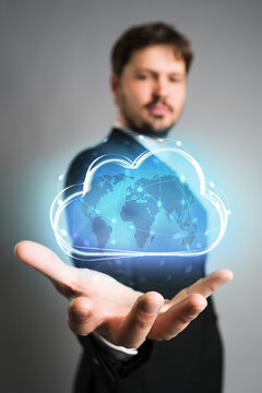 businessman interacting with a virtual cloud in front of grey background