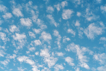 Beautiful small white clouds floating across the blue sky