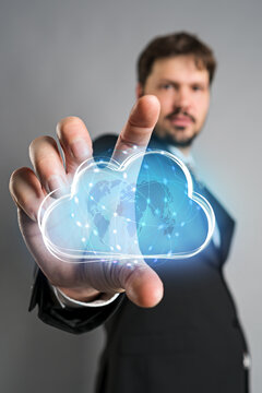 businessman interacting with a virtual cloud in front of grey background