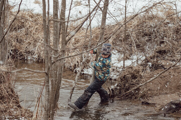 boy on the river during the first snow