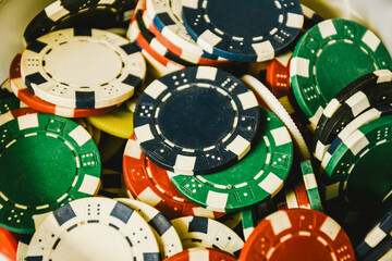 Close up of different color casino poker chips background. Close up of colorful poker chips. 