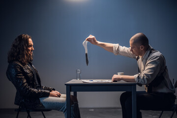 A detained white man with long hair receives irrefutable evidence of his guilt from a criminal...