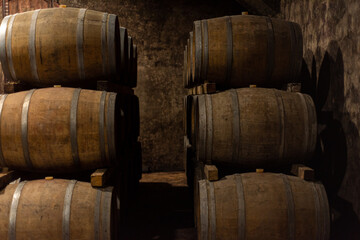 Wooden barrels for wine aging in the cellar. Italian wine.