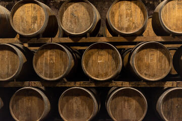 Wooden barrels for wine aging in the cellar. Italian wine.