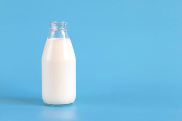 Bottle of fresh milk isolated on a blue background.