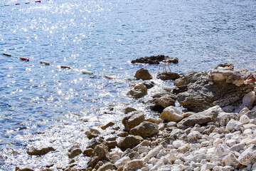 Sea. Coast. Rocky shore. The chair stands on stones by the sea