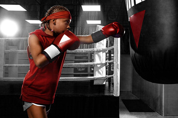 Boxing. Kids sport concept. Girl sportsman muay thai boxer fighting in gloves in gym.