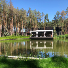 luxury big gazebo on the lake in forest