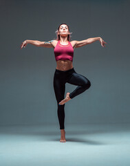 Full-length portrait of a modern female dancer dancing in sportswear.