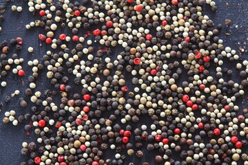 A mixture of peppers. Black, white, red polka dots. Isolated on a white background.