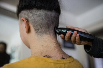 Woman getting hair buzzed off