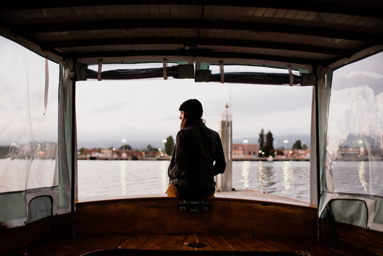 Young woman sitting alone looking off to the distance