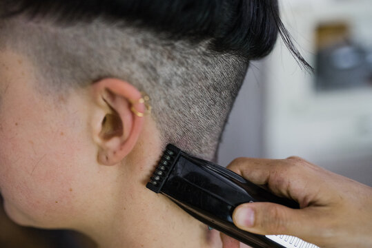 Woman getting hair buzzed off